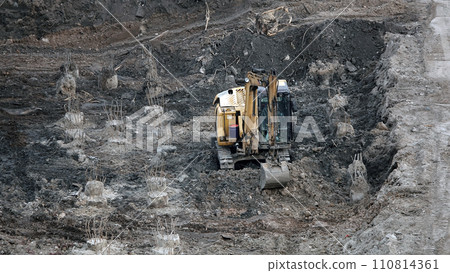 Kiev, Ukraine, October 17, 2018: Workers in the mud of a construction site at the stage of excavation; construction of a supermarket AUCHAN Kiev, Ukraine, October 17, 2018: Workers in the mud of a construction site at the stage of excavation; construction of a supermarket AUCHAN 110814361