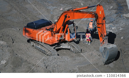 Kiev, Ukraine, October 17, 2018: Workers in the mud of a construction site at the stage of excavation; construction of a supermarket AUCHAN 110814366