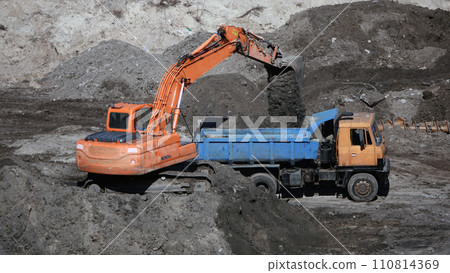 Kiev, Ukraine, October 17, 2018: Workers in the mud of a construction site at the stage of excavation; construction of a supermarket AUCHAN Kiev, Ukraine, October 17, 2018: Workers in the mud of a construction site at the stage of excavation; construction of a supermarket AUCHAN 110814369
