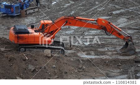 Kiev, Ukraine, October 17, 2018: Workers in the mud of a construction site at the stage of excavation; construction of a supermarket AUCHAN Kiev, Ukraine, October 17, 2018: Workers in the mud of a construction site at the stage of excavation; construction of a supermarket AUCHAN 110814381