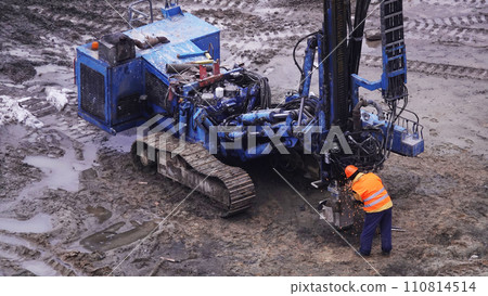 Kiev, Ukraine March 13, 2019: Workers repair equipment on the construction of the zero cycle foundation of the entertainment center 110814514