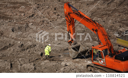 Kiev, Ukraine March 13, 2019: Tractors and excavators work on the construction of the foundation zero cycle Kiev, Ukraine March 13, 2019: Tractors and excavators work on the construction of the foundation zero cycle 110814521