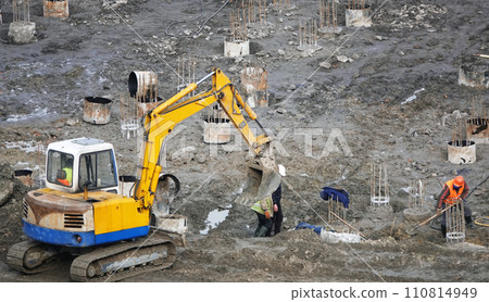 Kiev, Ukraine March 13, 2019: Workers and machinery - zero-cycle construction of the foundation of an entertainment center Kiev, Ukraine March 13, 2019: Workers and machinery - zero-cycle construction of the foundation of an entertainment center 110814949