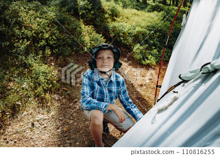 cute caucasian boy putting up a tent. Family camping concept 110816255