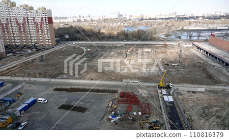 Kiev, Ukraine March 13, 2019: Tractors and excavators work on the construction of the foundation zero cycle Kiev, Ukraine March 13, 2019: Tractors and excavators work on the construction of the foundation zero cycle 110816379
