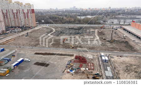 Kiev, Ukraine March 13, 2019: Tractors and excavators work on the construction of the foundation zero cycle Kiev, Ukraine March 13, 2019: Tractors and excavators work on the construction of the foundation zero cycle 110816381