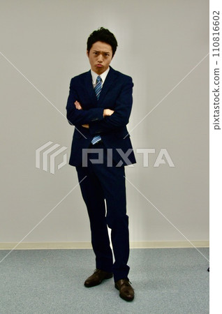 Young man with dissatisfied face with arms crossed 110816602