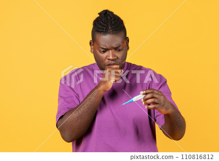Ill african american guy coughing holding thermometer over yellow background 110816812
