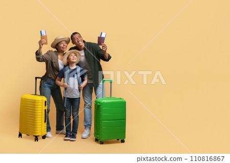 Happy family travelling together, showing passports and tickets 110816867