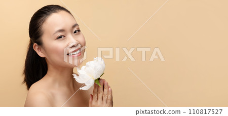 Cheerful millennial chinese naked woman with white flower, enjoy treatment Cheerful millennial chinese naked woman with white flower, enjoy treatment 110817527