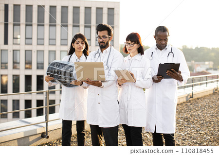 Arabian doctor using laptop showing results of patient's tests. Arabian doctor using laptop showing results of patient's tests. 110818455