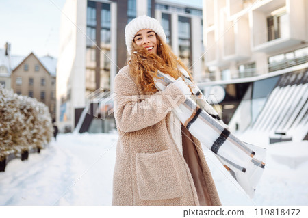 Portrait of young woman in the winter street. Fashion style. 110818472