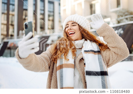 Young woman taking selfie in winter street. Holidays, rest, blogging. 110818480