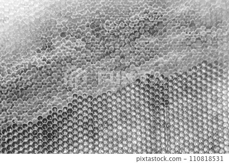 Drop of bee honey drip from hexagonal honeycombs filled with golden nectar Drop of bee honey drip from hexagonal honeycombs filled with golden nectar 110818531