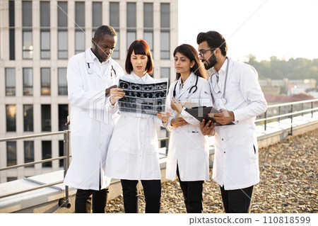 Doctors discussing x-ray image. 110818599
