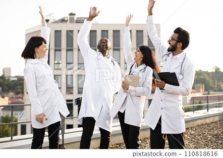 Multinational conference of doctors outdoors on rooftop of modern clinic. Multinational conference of doctors outdoors on rooftop of modern clinic. 110818616