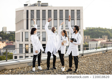 Multinational conference of doctors outdoors on rooftop of modern clinic. Multinational conference of doctors outdoors on rooftop of modern clinic. 110818620