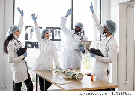 Group of medics celebrating success by raising their hands. Group of medics celebrating success by raising their hands. 110818635