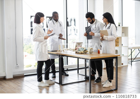 African man teacher teaching anatomy to university students or young doctors. African man teacher teaching anatomy to university students or young doctors. 110818733