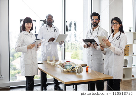 Young medical students on anatomy lesson in classroom looking at camera. 110818755