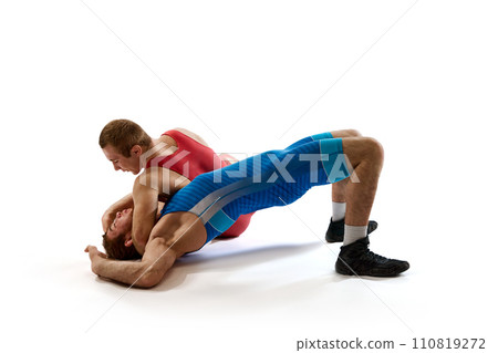 Two strong and competitive man in red and blue sportwear fighting in action against white studio background. 110819272