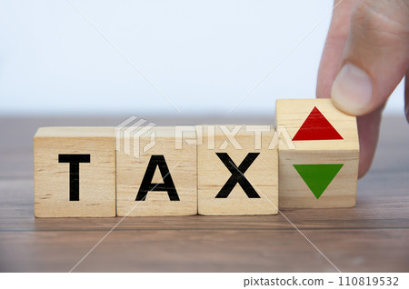 Hand turning blank wooden cubes with word tax. Taxation time concept 110819532