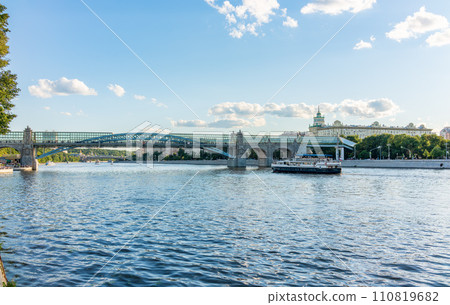 View of the Moscow river embakment, Pushkinsky bridge and cruise ships at sunset. View of the Moscow river embakment, Pushkinsky bridge and cruise ships at sunset. 110819682