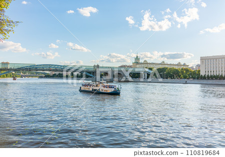 View of the Moscow river embakment, Pushkinsky bridge and cruise ships at sunset. View of the Moscow river embakment, Pushkinsky bridge and cruise ships at sunset. 110819684