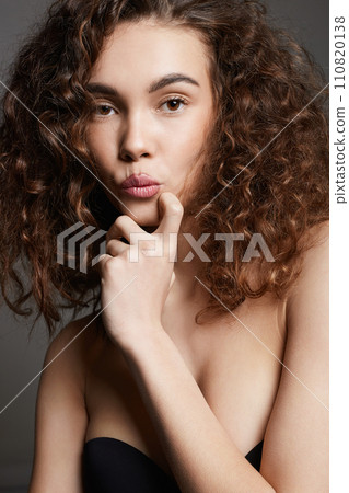 beautiful young woman with curly hair. pretty funny girl 110820138