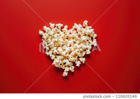 popcorn with shaped heart on red background. Cinema valentines day concept 110820149