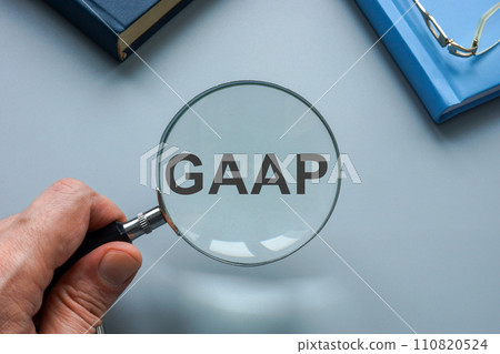 GAAP Generally Accepted Accounting Principles. A hand with a magnifying glass points to an abbreviation. GAAP Generally Accepted Accounting Principles. A hand with a magnifying glass points to an abbreviation. 110820524