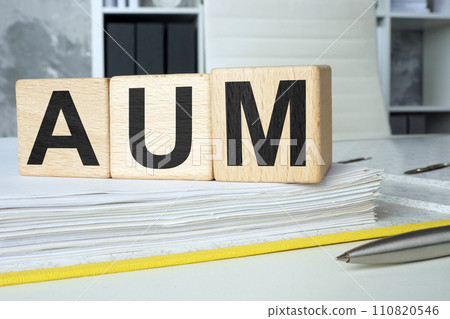 An open folder and cubes on it. AUM assets under management. An open folder and cubes on it. AUM assets under management. 110820546