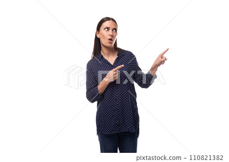 a young woman with black hair dressed in a blue blouse looks away and points her finger a young woman with black hair dressed in a blue blouse looks away and points her finger 110821382