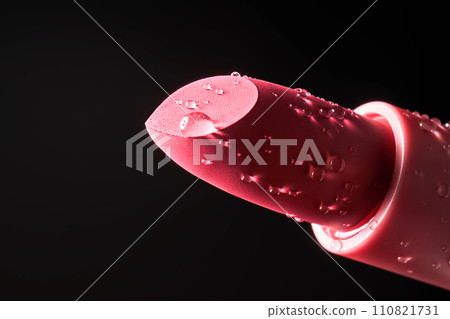 Red lipstick with water drops on a dark background. Red lipstick with water drops on a dark background. 110821731
