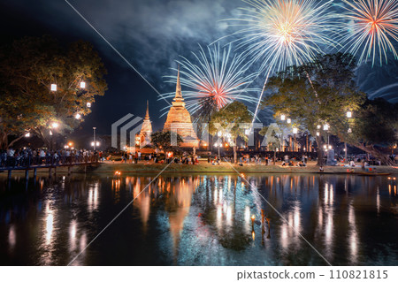 Fireworks celebration of Loy Krathong at Sukhothai Historical Park festival, buddha pagoda stupa in a temple, Sukhothai, Thailand. Thai buddhist temple architecture at night. Tourist attraction. Fireworks celebration of Loy Krathong at Sukhothai Historical Park festival, buddha pagoda stupa in a temple, Sukhothai, Thailand. Thai buddhist temple architecture at night. Tourist attraction. 110821815