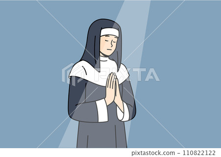 Nun prays to god with palms folded in front chest, standing under beam light in cathedral building 110822122