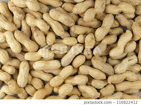 Close-up of unpeeled peanuts, top view, peanut background. Close-up of unpeeled peanuts, top view, peanut background. 110822412
