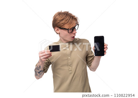 handsome young caucasian male promoter with red hair and a tattoo on his arm dressed in a khaki 110822954