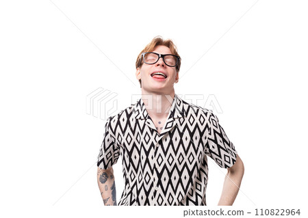 young european guy with red hair wears glasses for vision correction and shows tongue 110822964