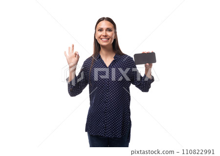 young charming positive successful woman with black hair dressed in a blue blouse holding a young charming positive successful woman with black hair dressed in a blue blouse holding a 110822991