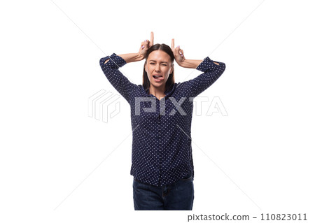 young european slender brunette woman in blue clothes makes a grimace 110823011