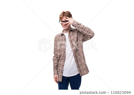 young stylish man with red hair is dressed in a summer plaid shirt young stylish man with red hair is dressed in a summer plaid shirt 110823094