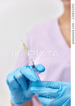 Woman holding medical injection syringe in her hand 110823291
