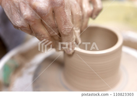 male hands making ceramic cup on pottery wheel, Close-up male hands making ceramic cup on pottery wheel, Close-up 110823303