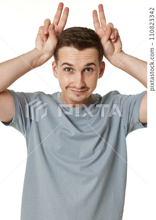 portrait of young funny man grimacing on white background portrait of young funny man grimacing on white background 110823342