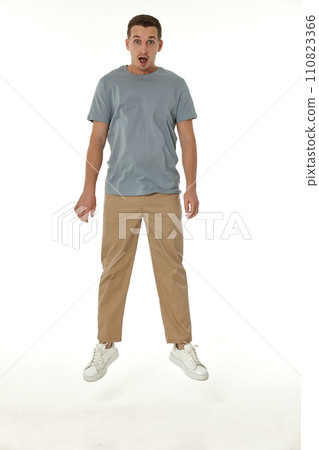 surprised guy looking at camera on white studio background 110823366