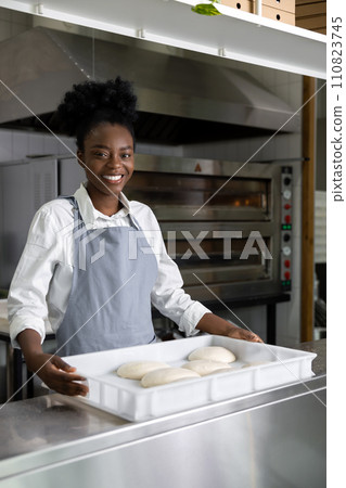 African american young woman preparing pizza in the kitchen 110823745