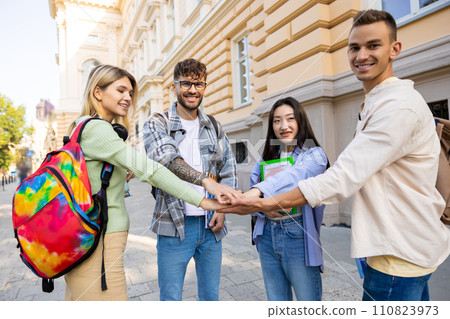 Students holding hands successful teamwork standing in university campus. Students holding hands successful teamwork standing in university campus. 110823973