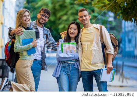 University students standing outdoor after classes. 110823998