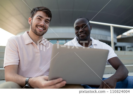 Two colleagues working together remotely and looking involved Two colleagues working together remotely and looking involved 110824004
